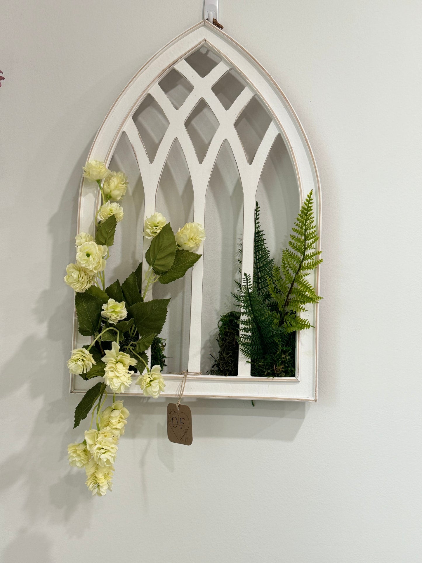 Hops on a white distressed arch