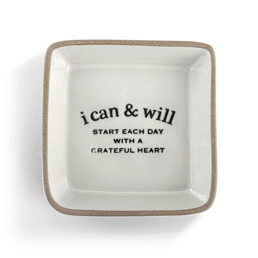 White ceramic trinket dish with motivational quote on a white background