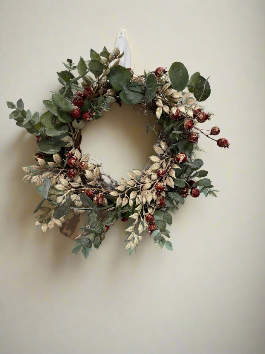 Decorative wreath with green leaves and red berries