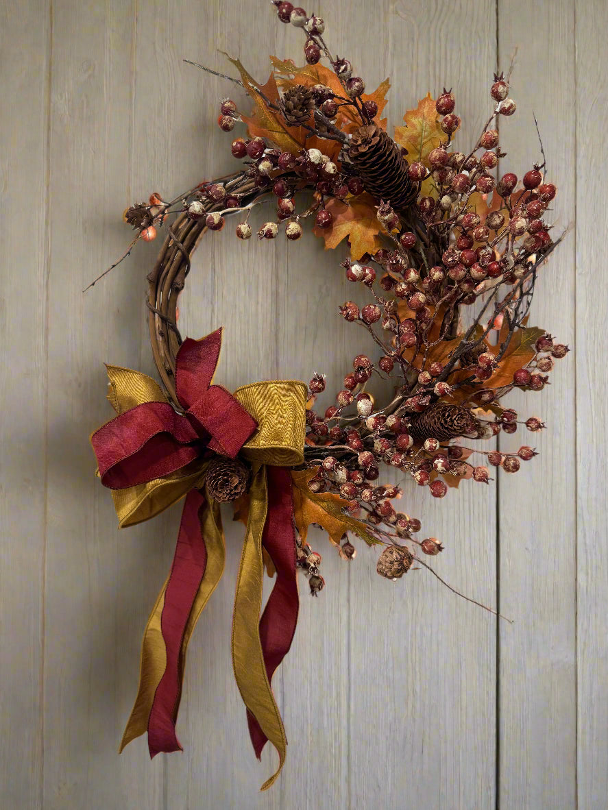 Decorative wreath with autumnal elements and ribbons