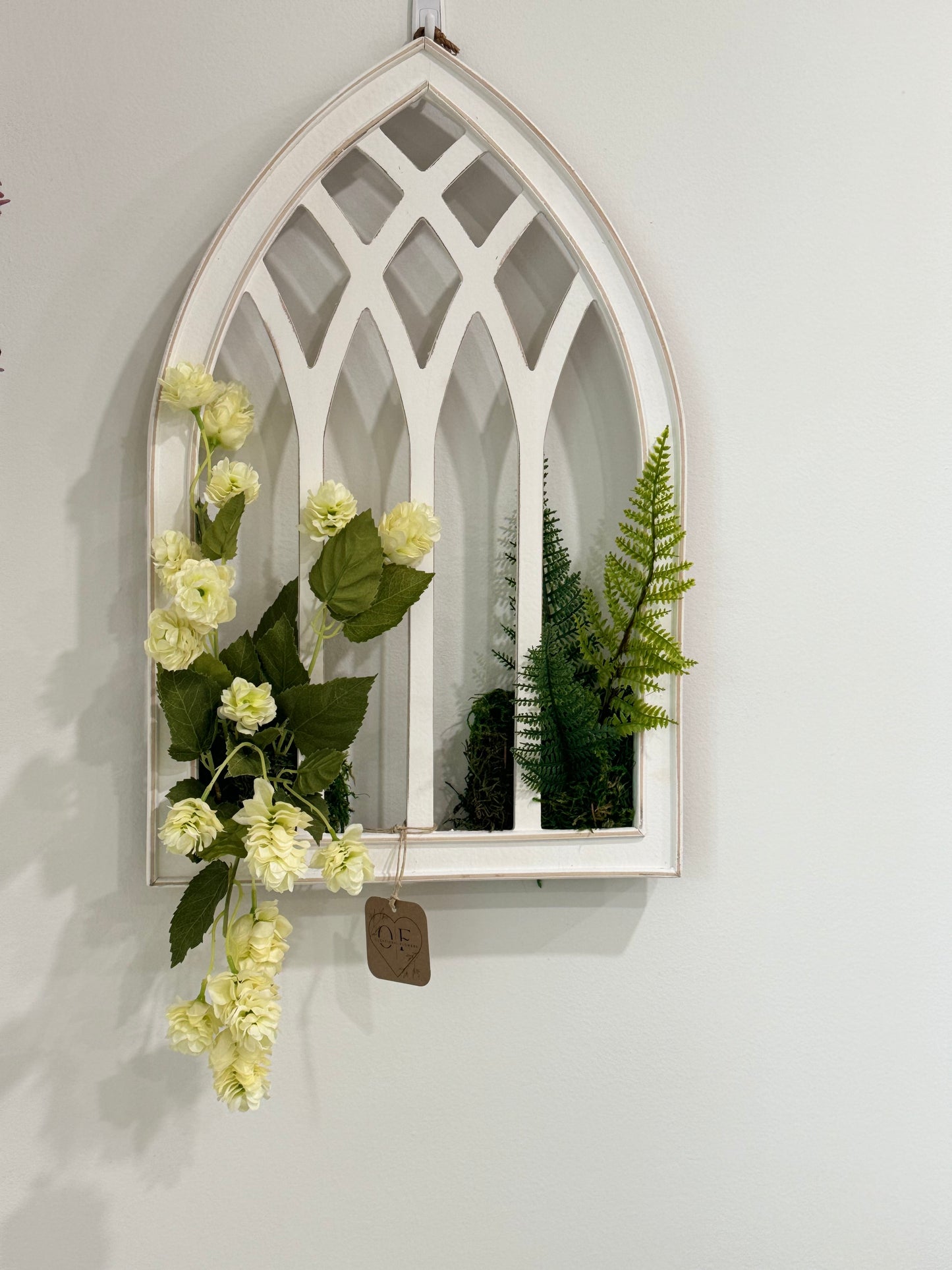 Hops on a white distressed arch