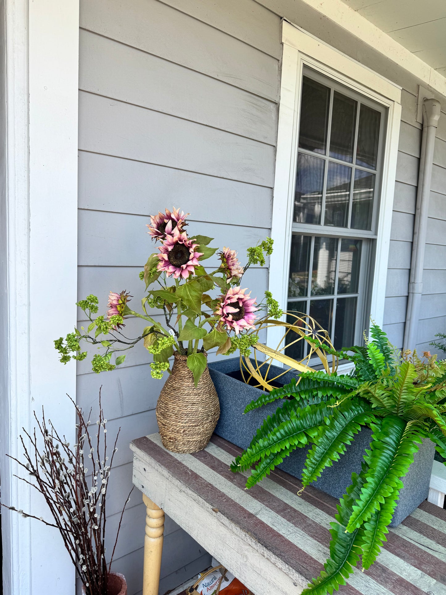 Sunflowers and Green Blossom branch Arrangement in Seagrass Vase